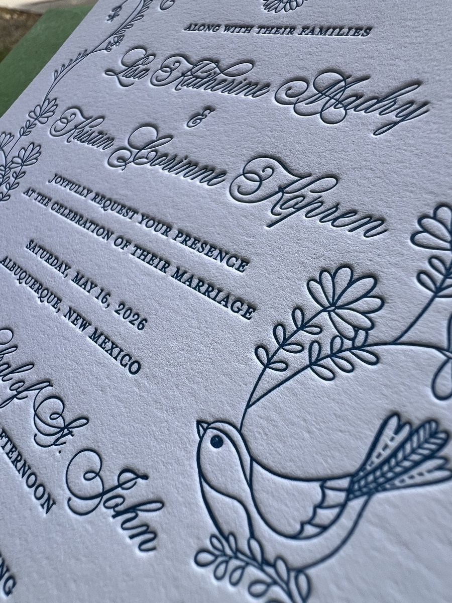 Letterpress wedding invitation in dusty blue line art with doves and wildflowers, with green and blue patterned envelopes, image 3 of 3